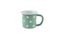Eine pastellgrün-gepunktete Emaille-Tasse