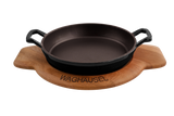 Eine schwarze, runde Gusseisenpfanne mit Holzuntersetzer